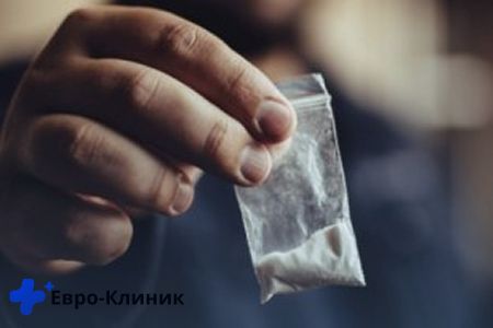 Рука протягивает пакетик с наркотиками